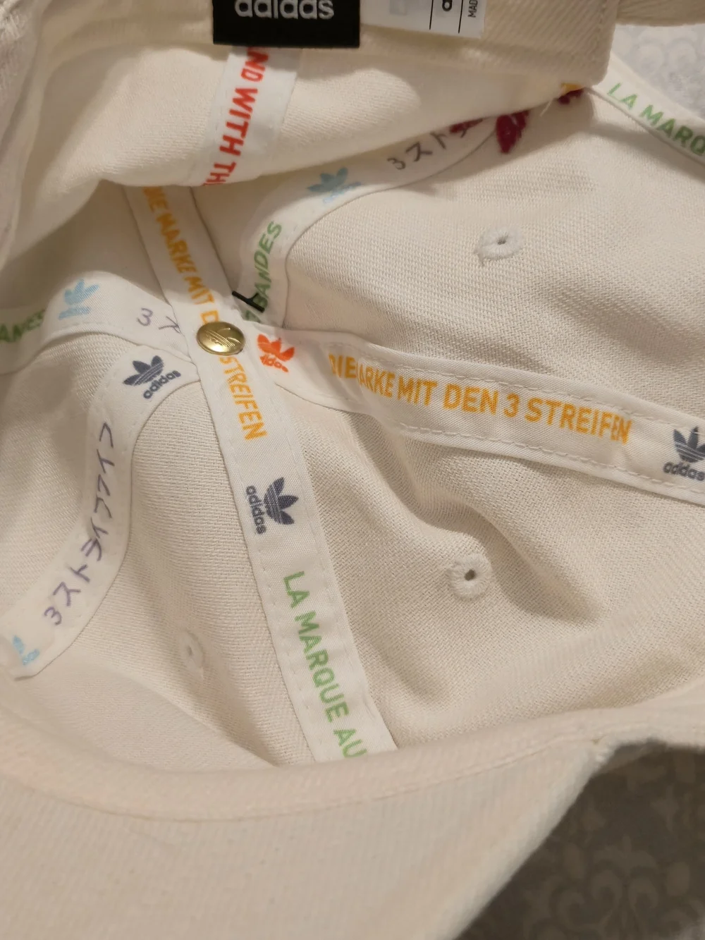 NWT Adidas Originals cap features rainbow-colored embroidered trefoil log.